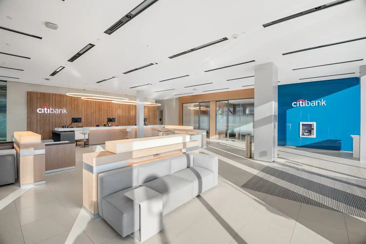 Bank branch teller hall with daylit storefront glazing