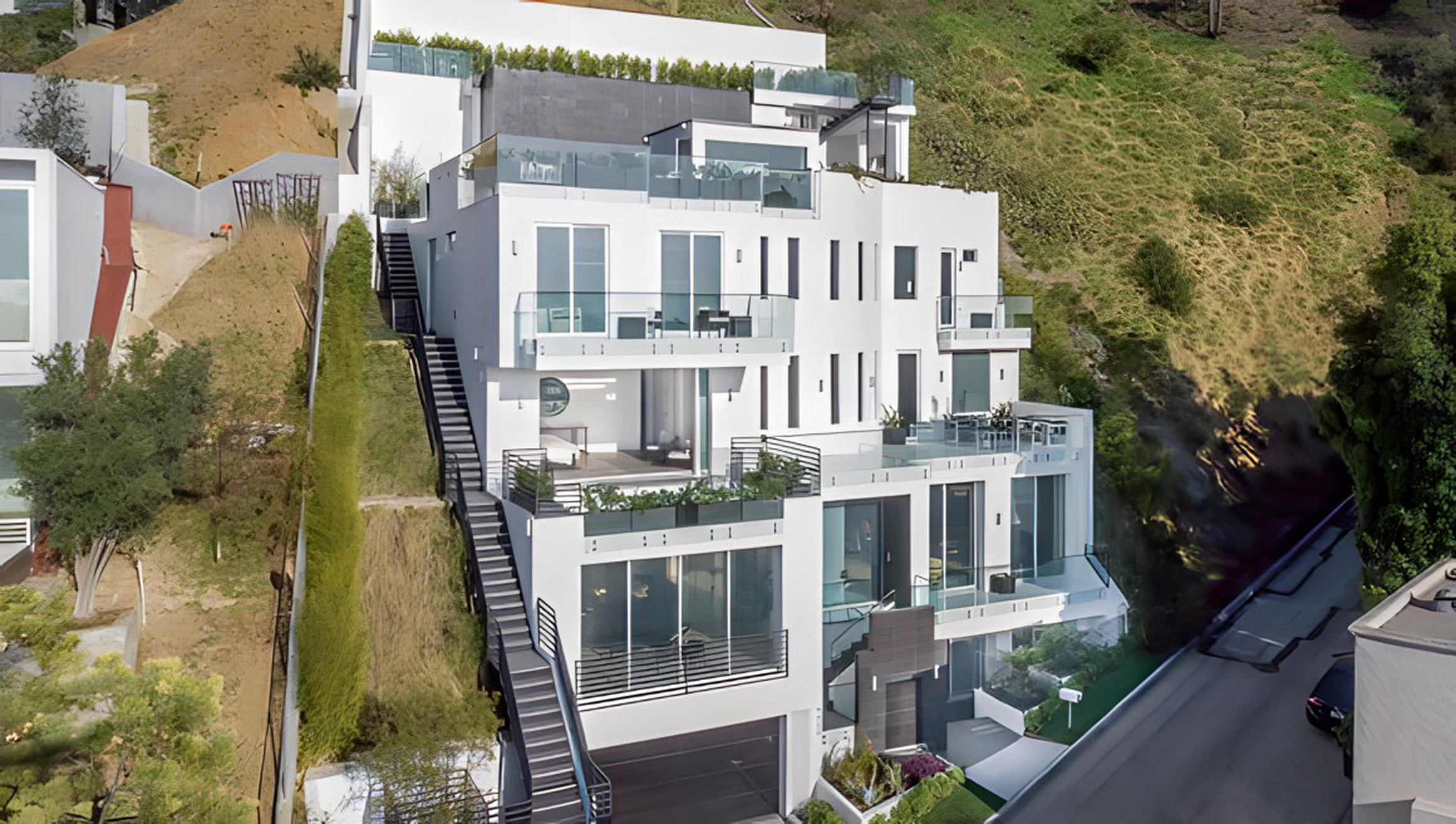 Aerial view of the Bel Air residence stepping down the hillside with rooftop decks