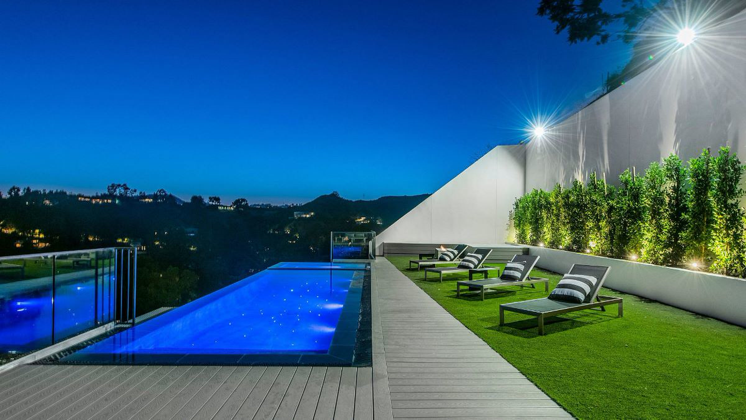 Bel Air pool terrace at blue hour with lounge seating and canyon views