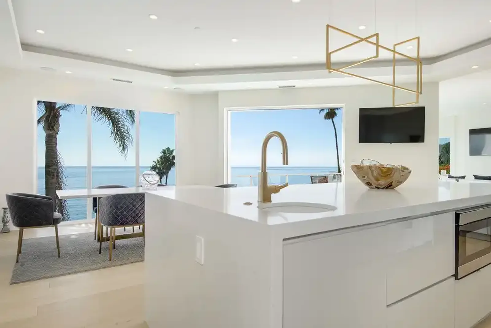 White kitchen with island and ocean view windows