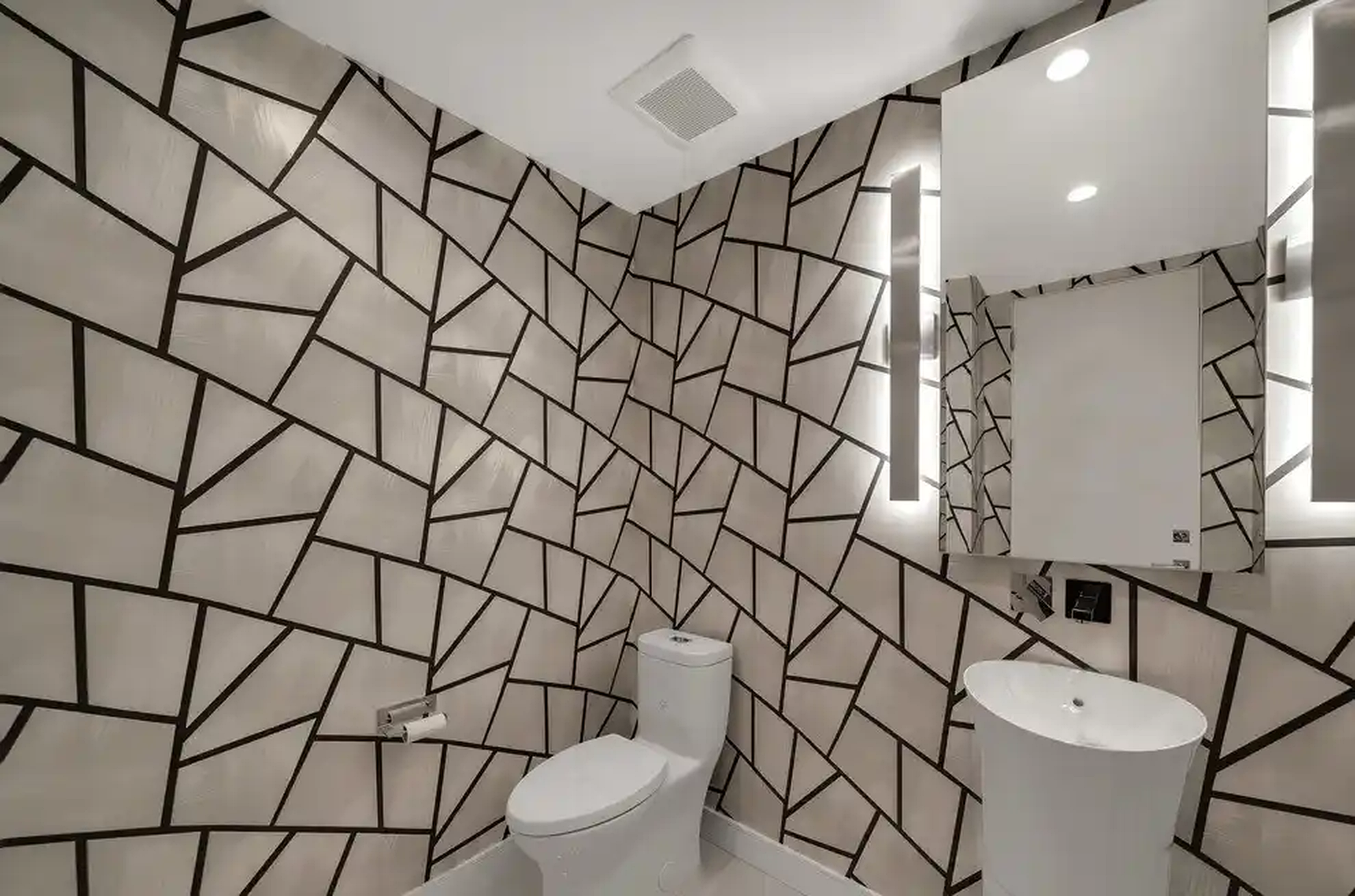 Castellamare powder room with geometric stone wall