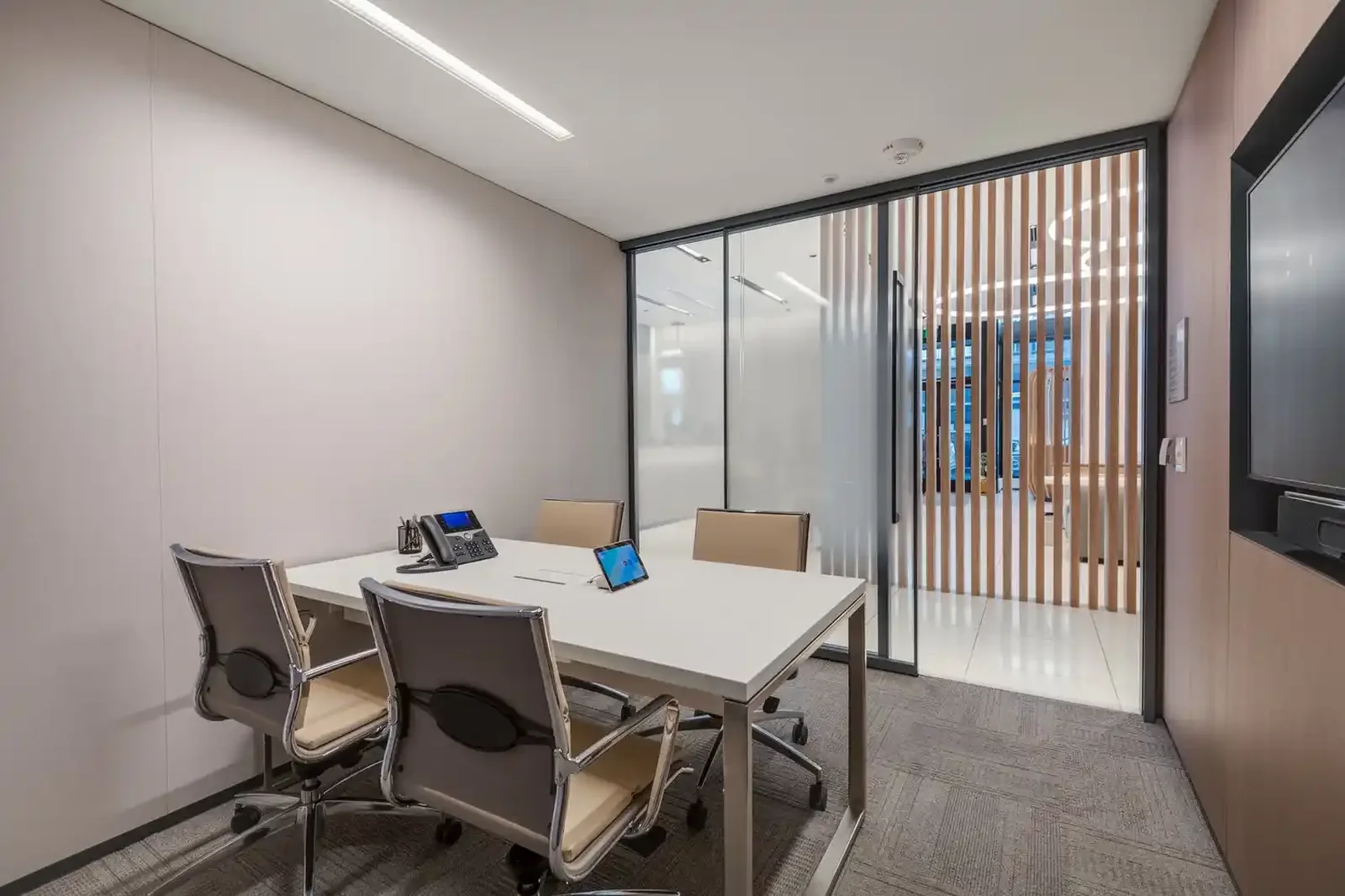 Glass-walled meeting room inside a bank branch