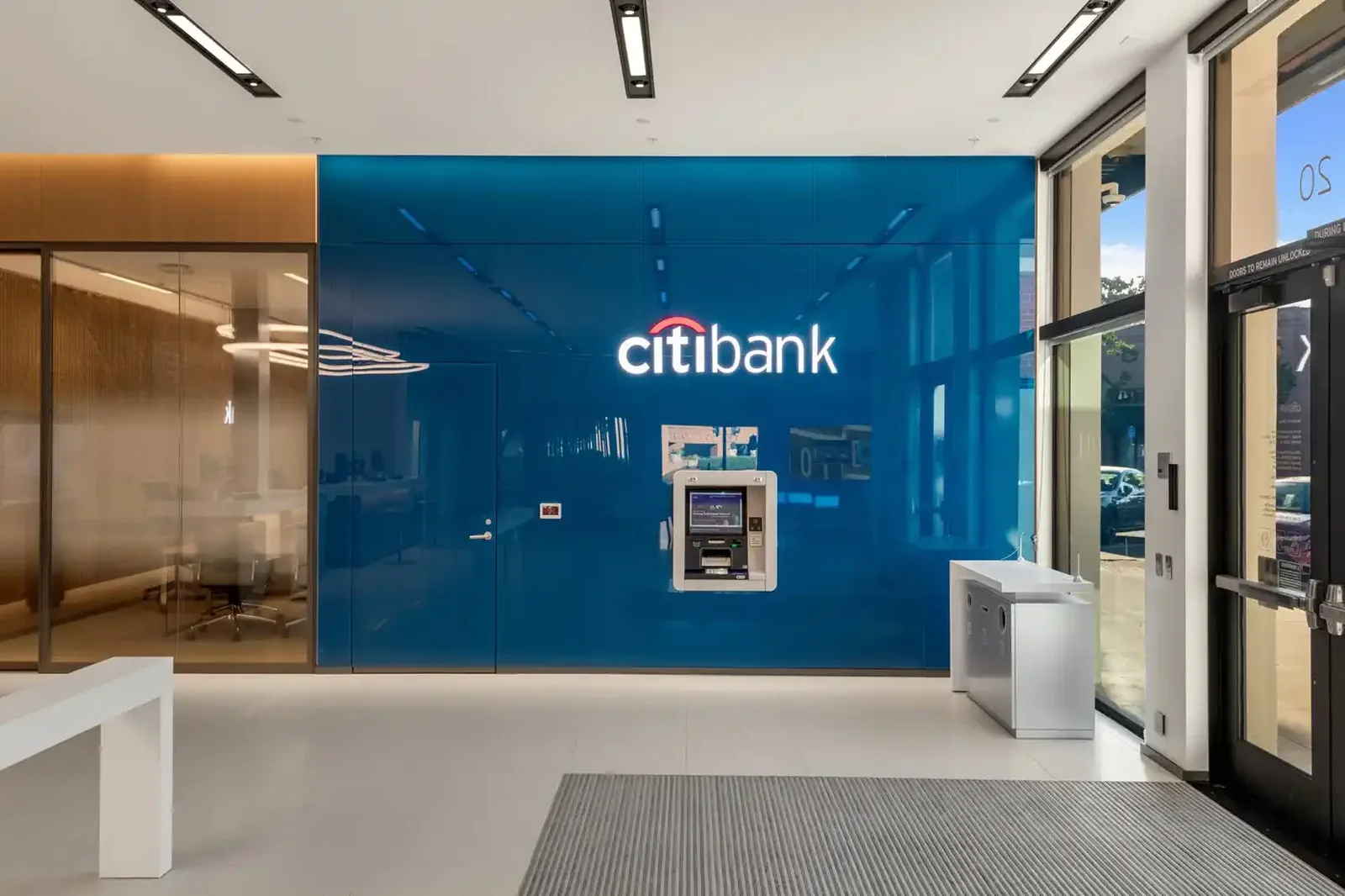 Branch entry vestibule with ATM bank and illuminated brand wall