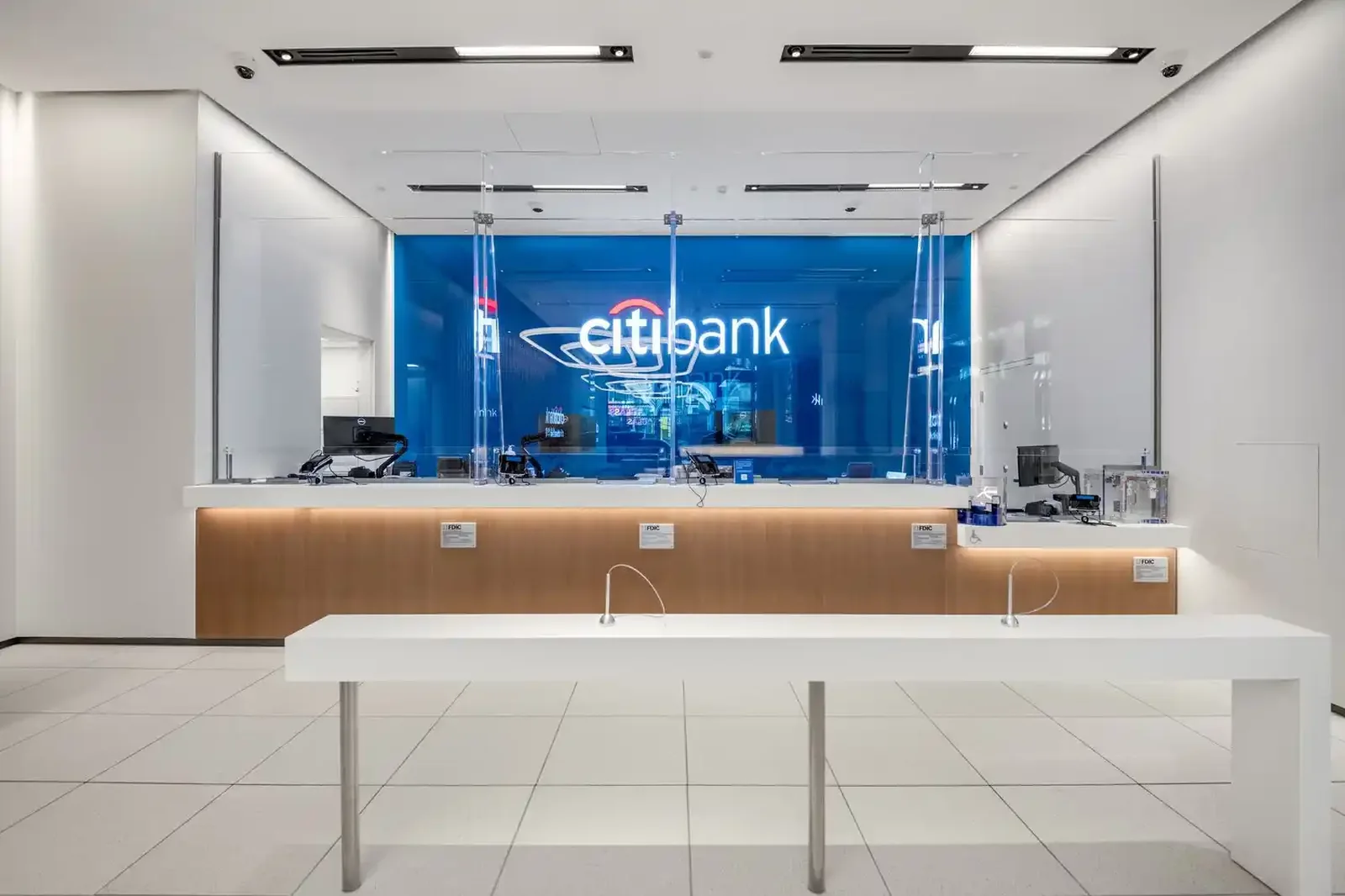 Teller hall with service counter and backlit brand wall