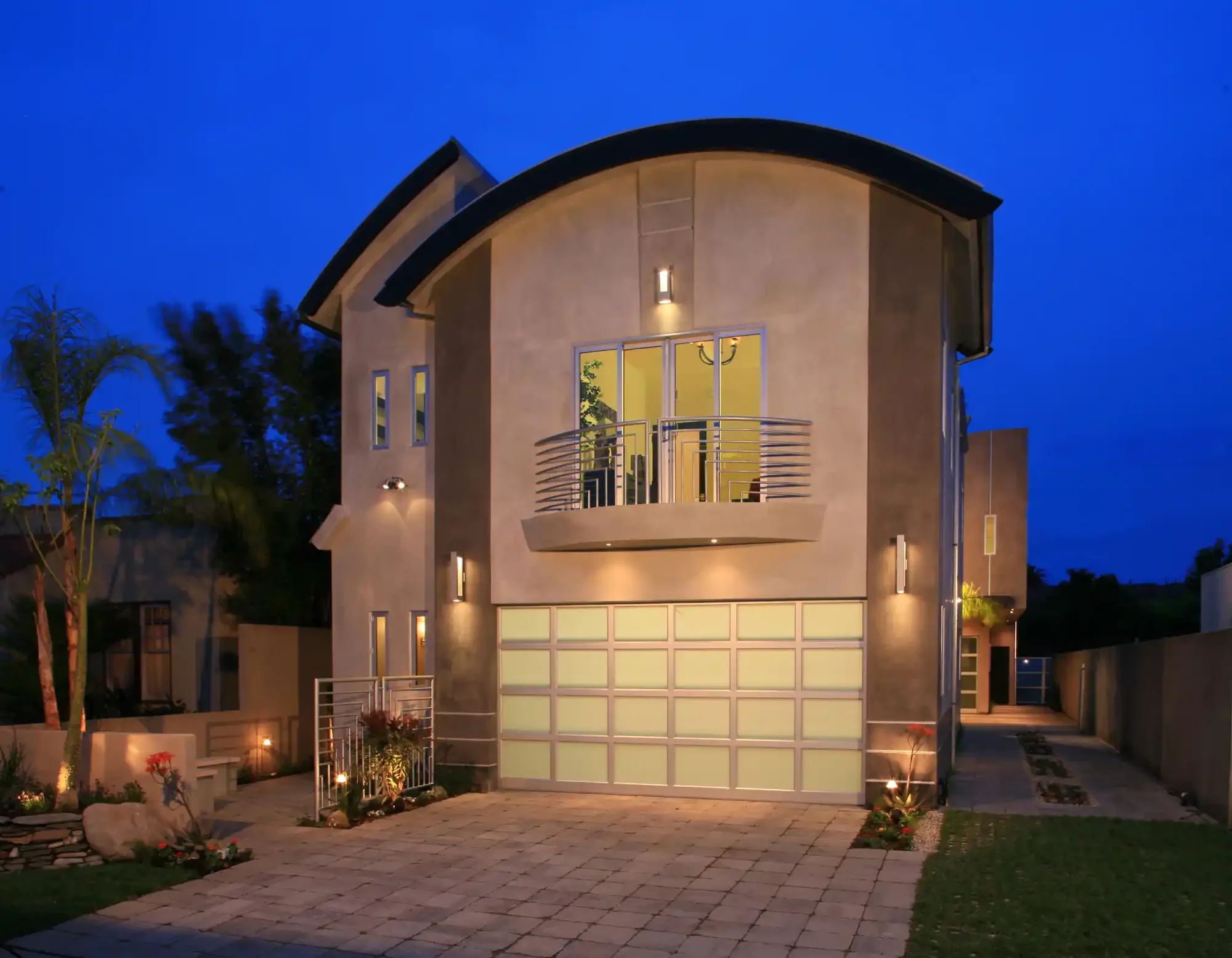 Residence exterior with garage and evening lighting