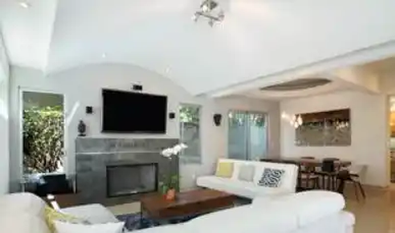 Colby living room with fireplace and kitchen beyond