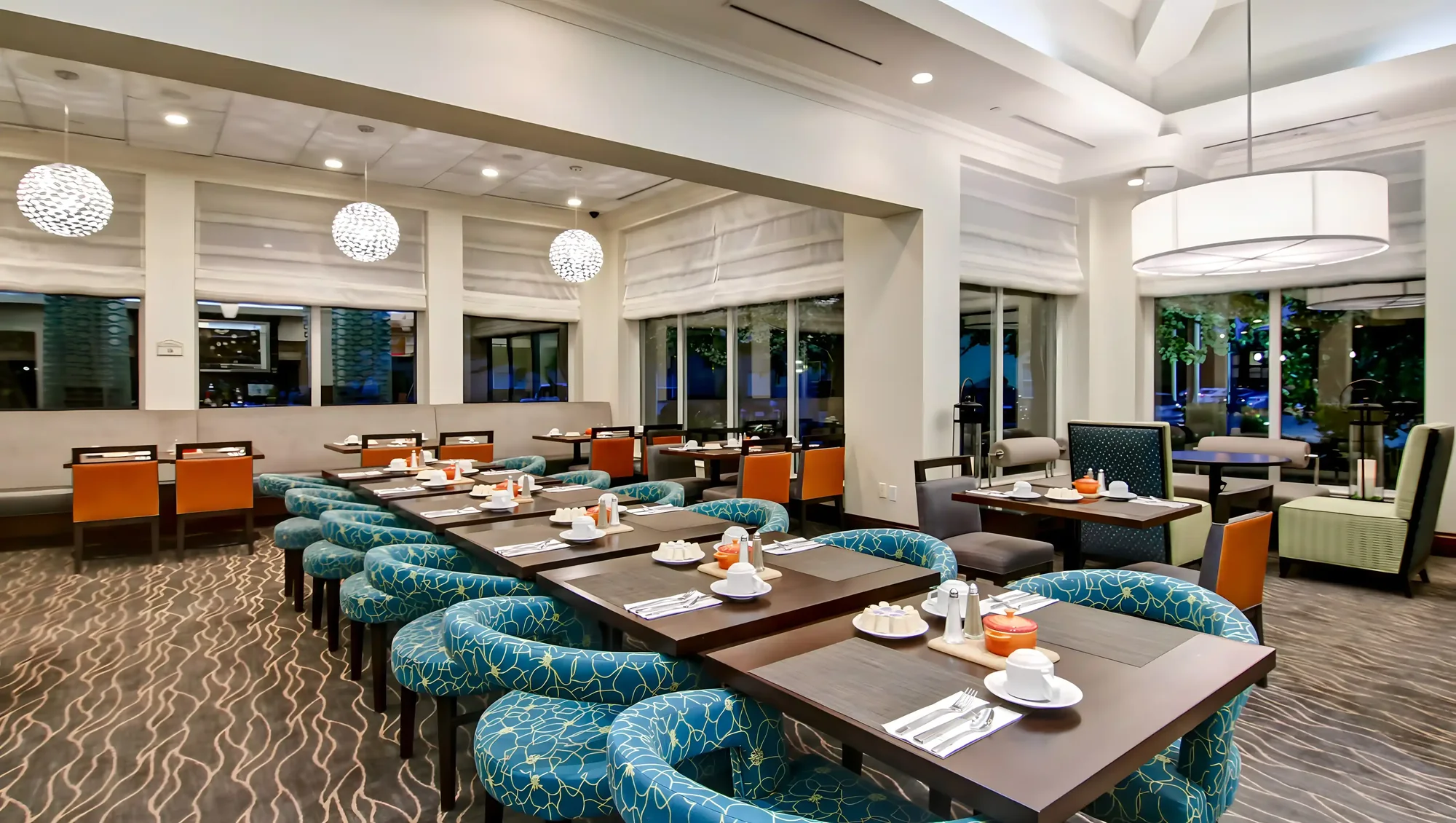 Hotel dining room with teal banquette seating