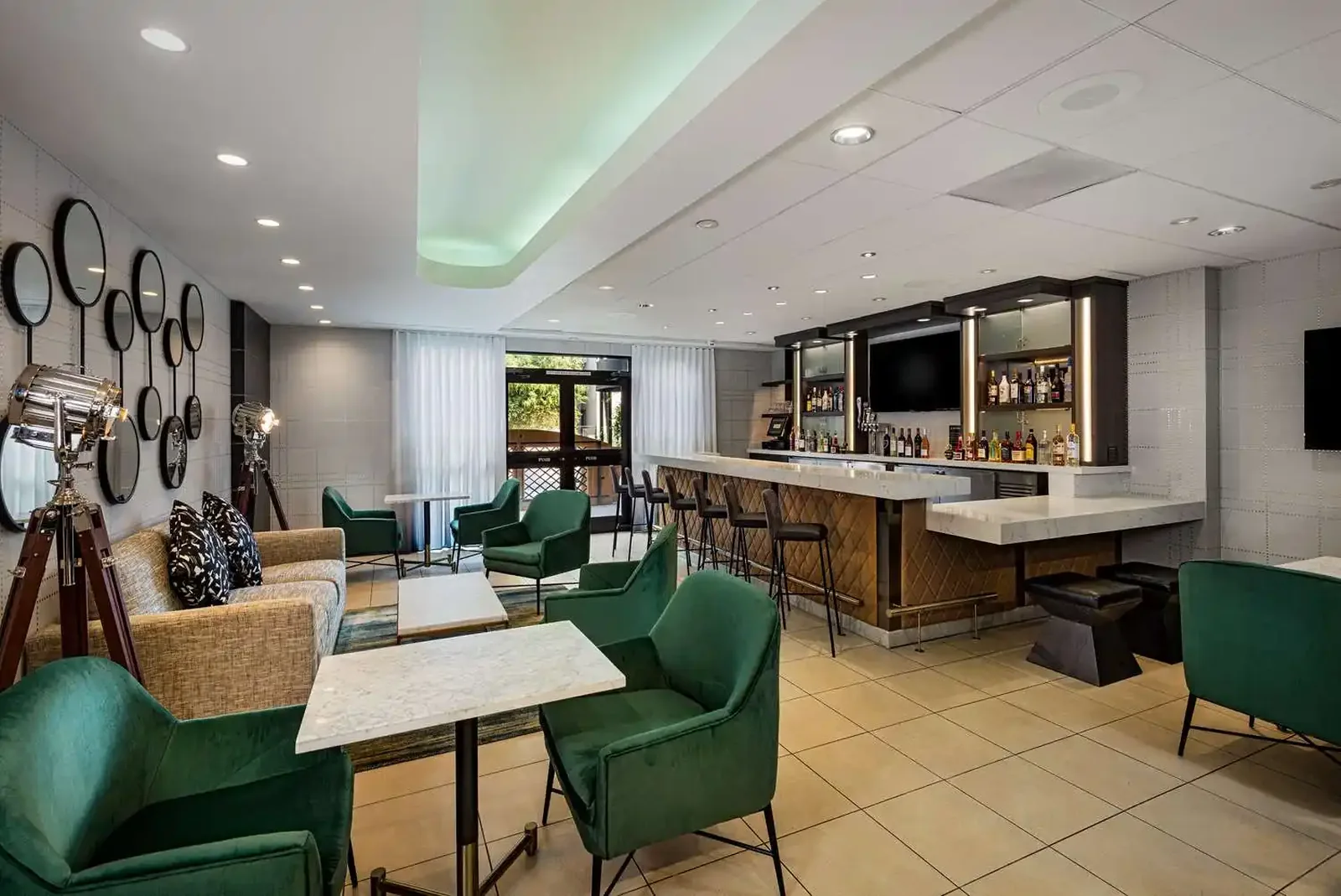 Hotel bar and lounge with green upholstered seating