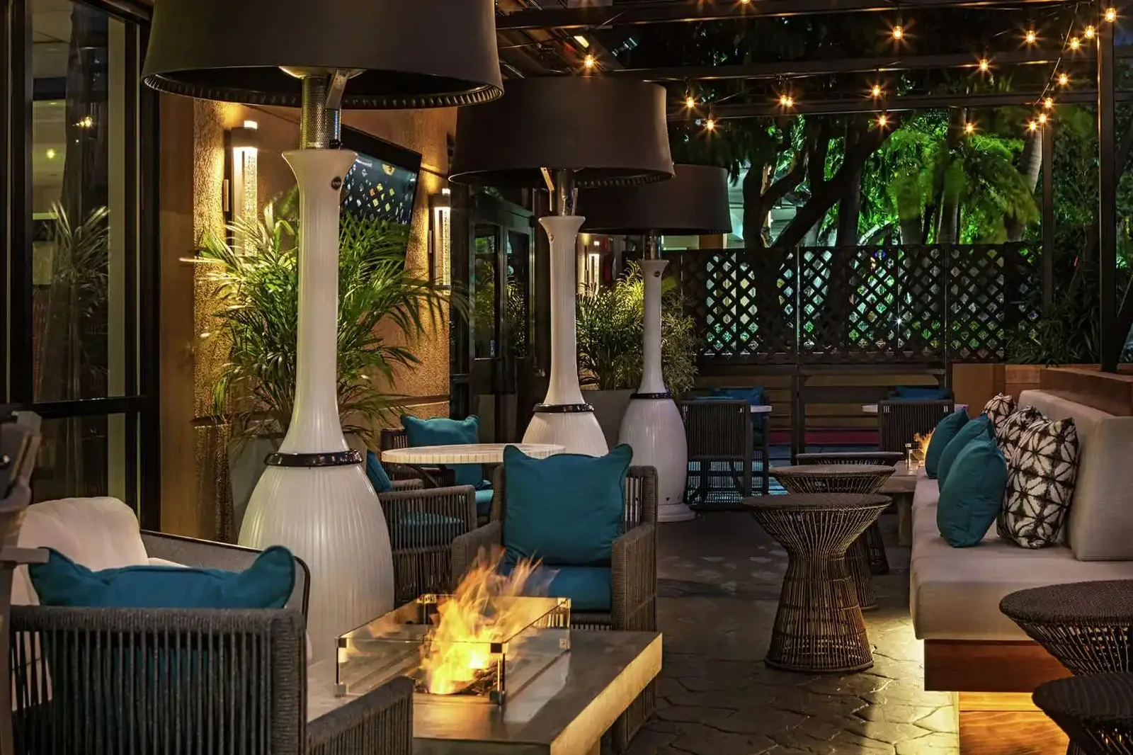 Hotel outdoor patio with fire feature and string lighting