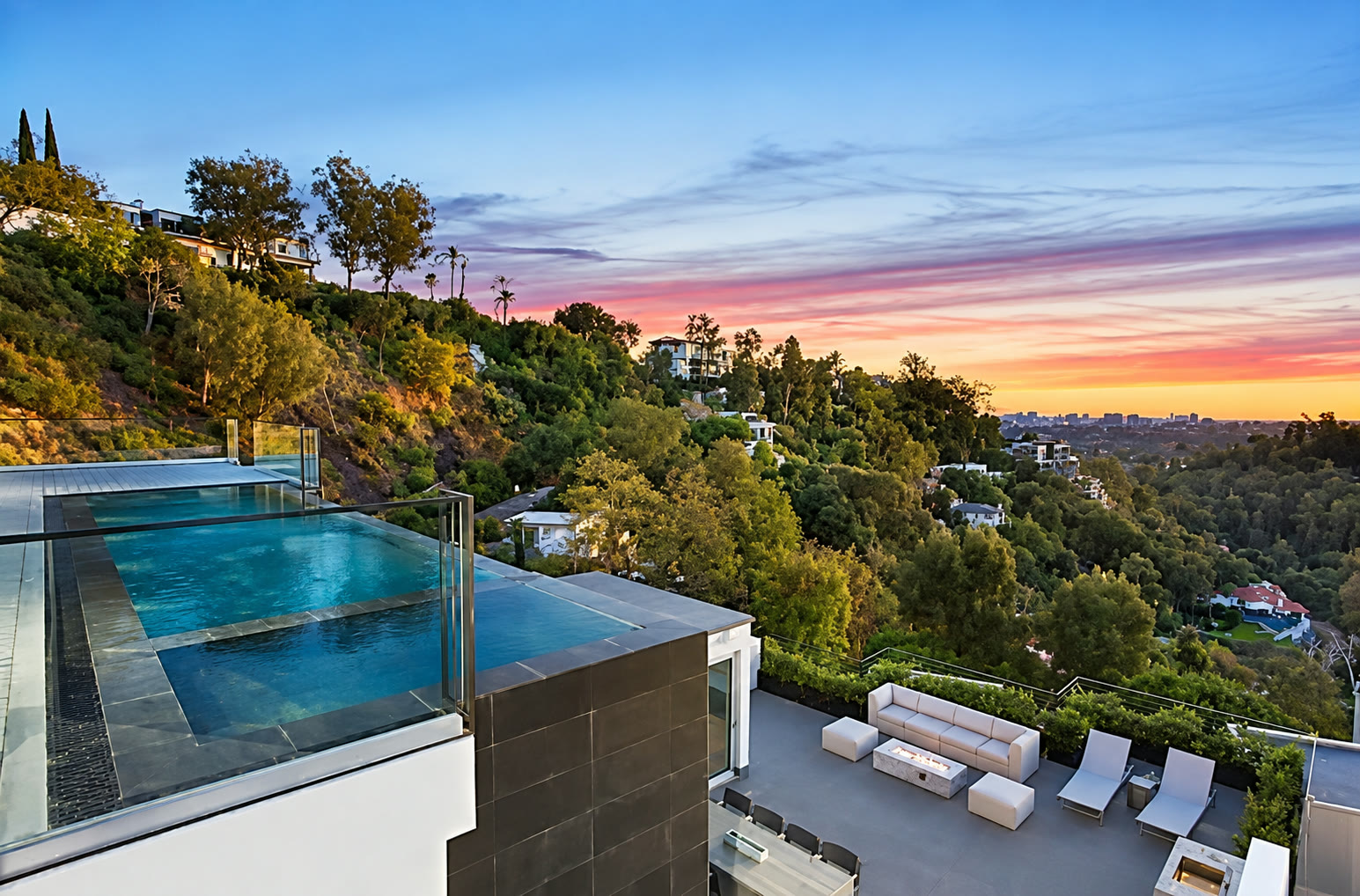 Contemporary hillside residence with pool at golden hour