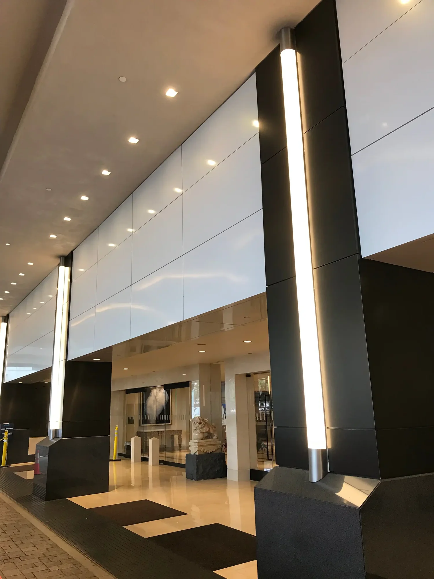 Hotel lobby with backlit feature panel and dark ceiling