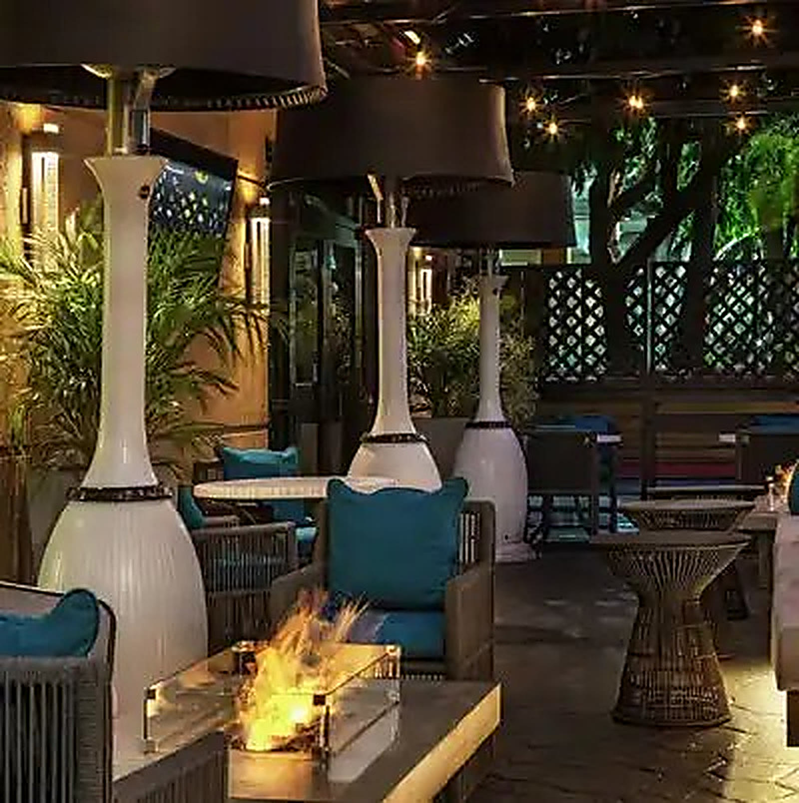 Restaurant patio with fire features at night