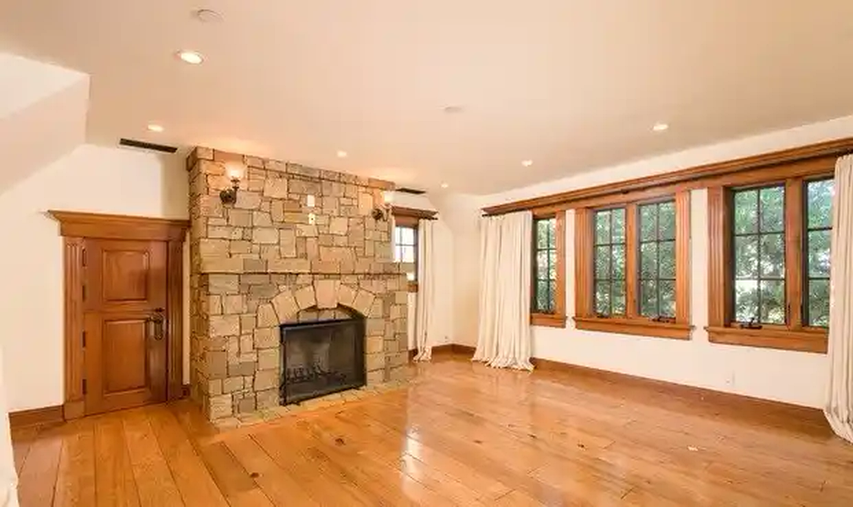 Torreyson living room with stone fireplace and wood floors