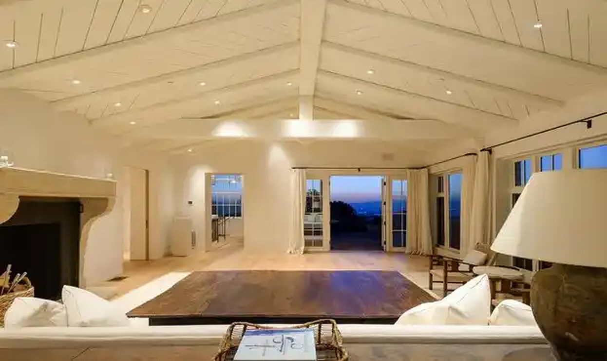 Torreyson open living room with exposed ceiling beams