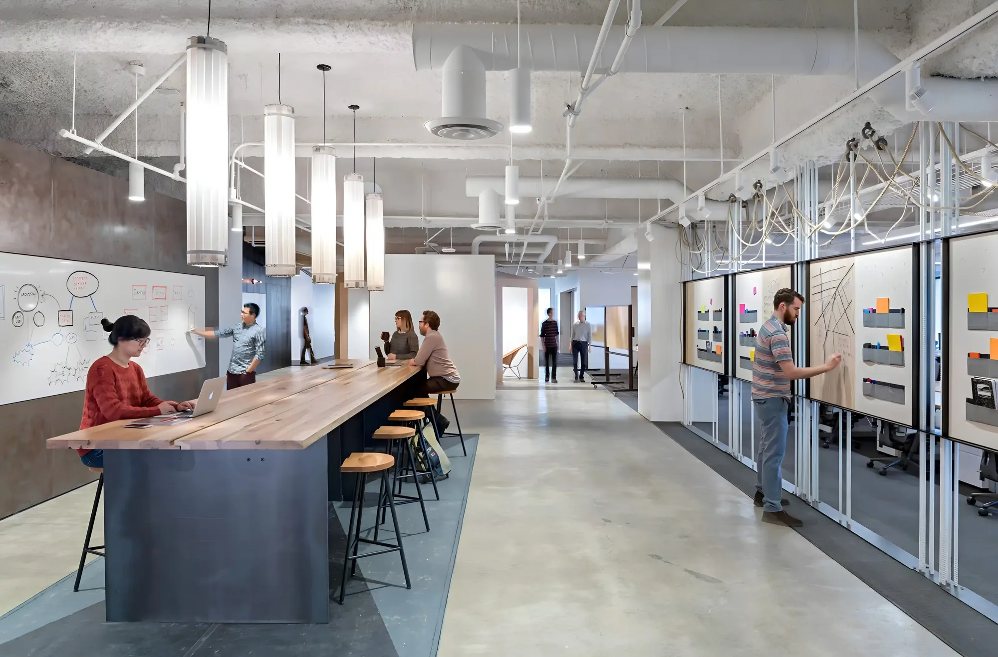Long communal work table under pendant lighting